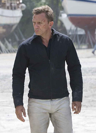 Daniel Craig as James Bond in Quantum of Solace wears stone colored jeans and a dark blue windbreaker
