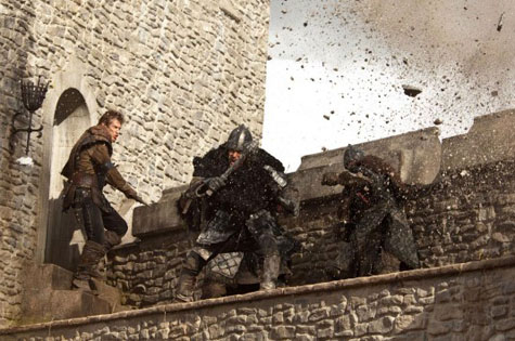 Ironclad movie battlement scene of cannonballs hitting the castle wall and spraying debris on 3 men