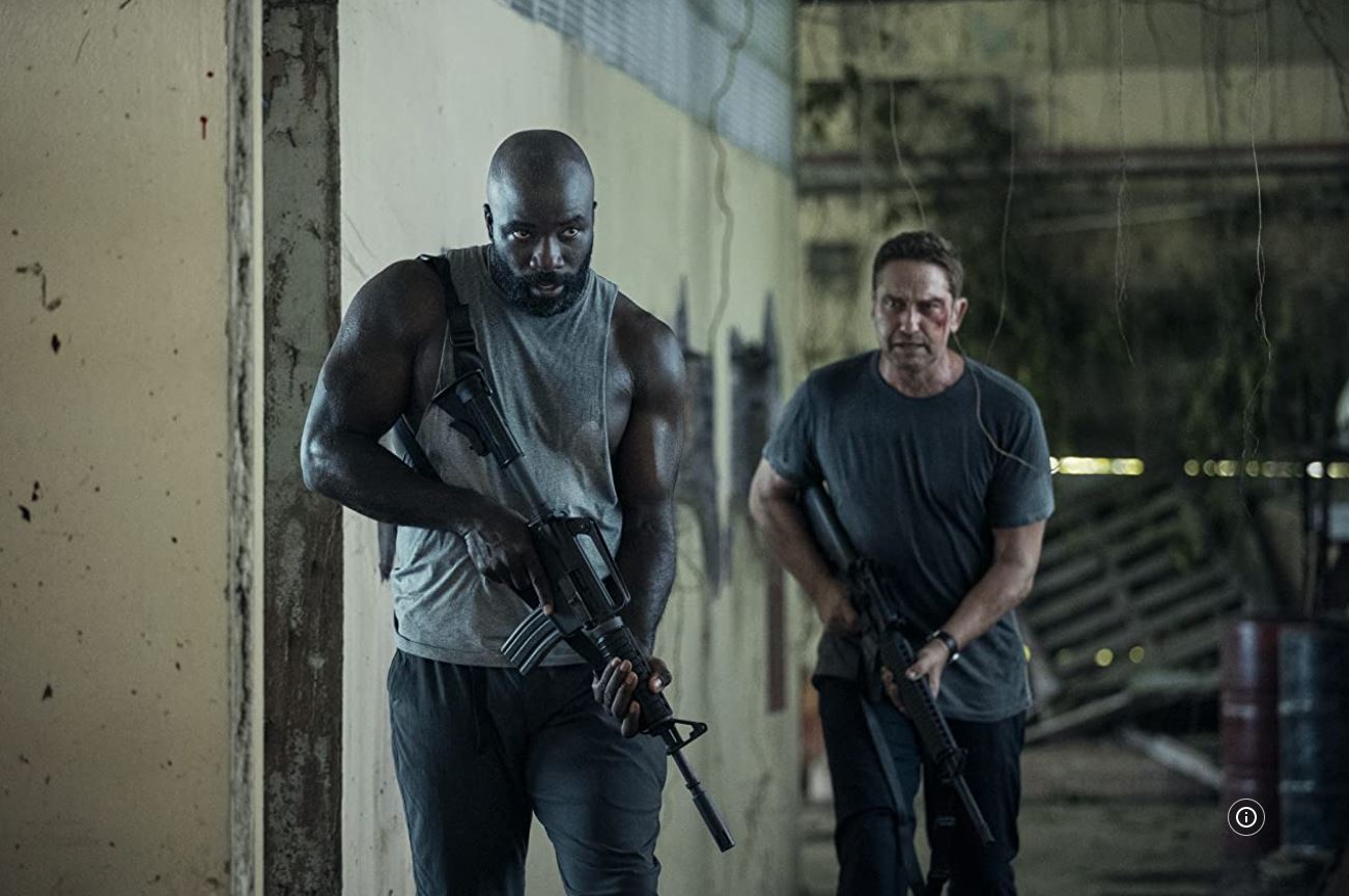 Mike Colter and Gerard Butler with guns in PLANE