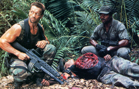 Predator movie Dutch and Dillon examine Blain's body and the cauterized wound