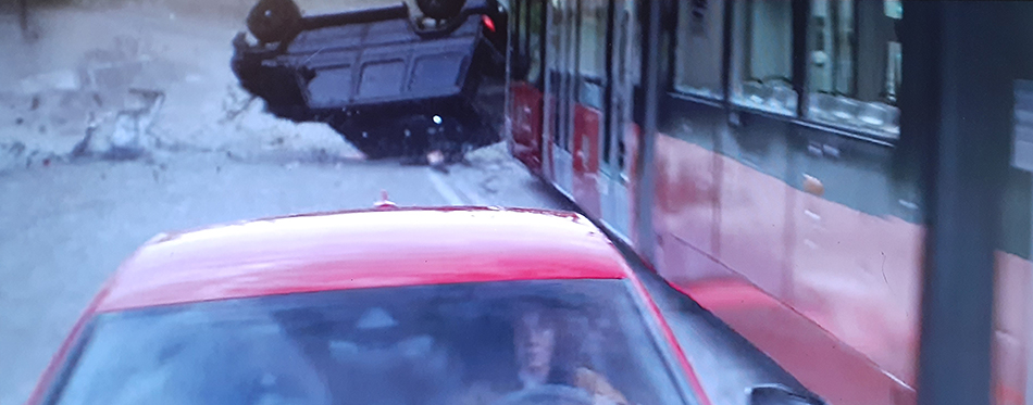 The Gray Man chase scene with streetcar SUV flip